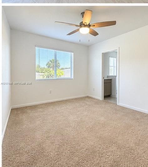 Room featuring neutral carpeting, a ceiling fan with integrated lighting, and a single-pane window with horizontal blinds