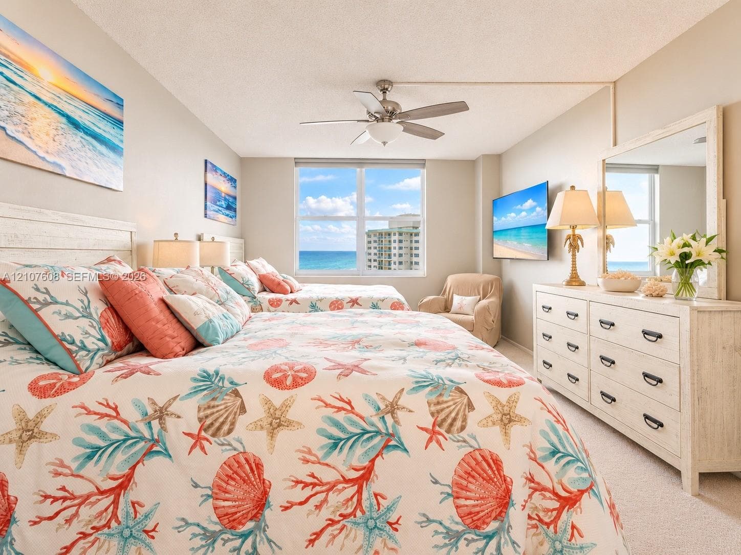 Bedroom featuring a large multi-pane window with water outlook, carpeted flooring, and a ceiling-mounted light fixture with integrated fan