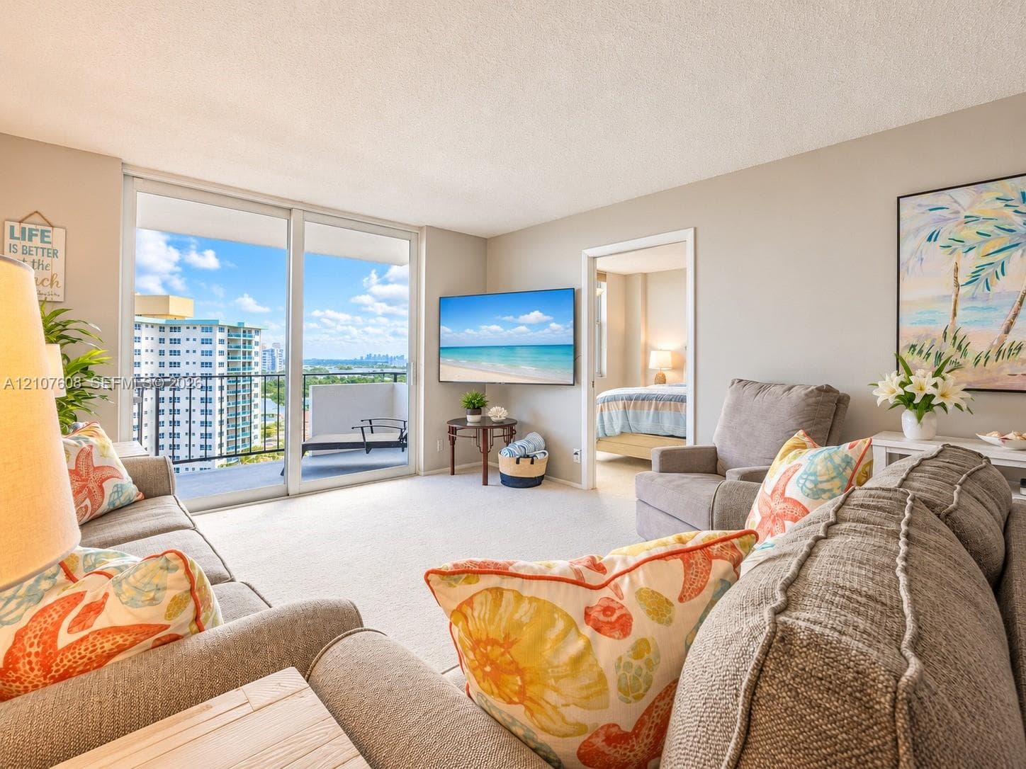 Living space featuring wall-to-wall carpeting and floor-to-ceiling glass sliding doors opening to a private balcony