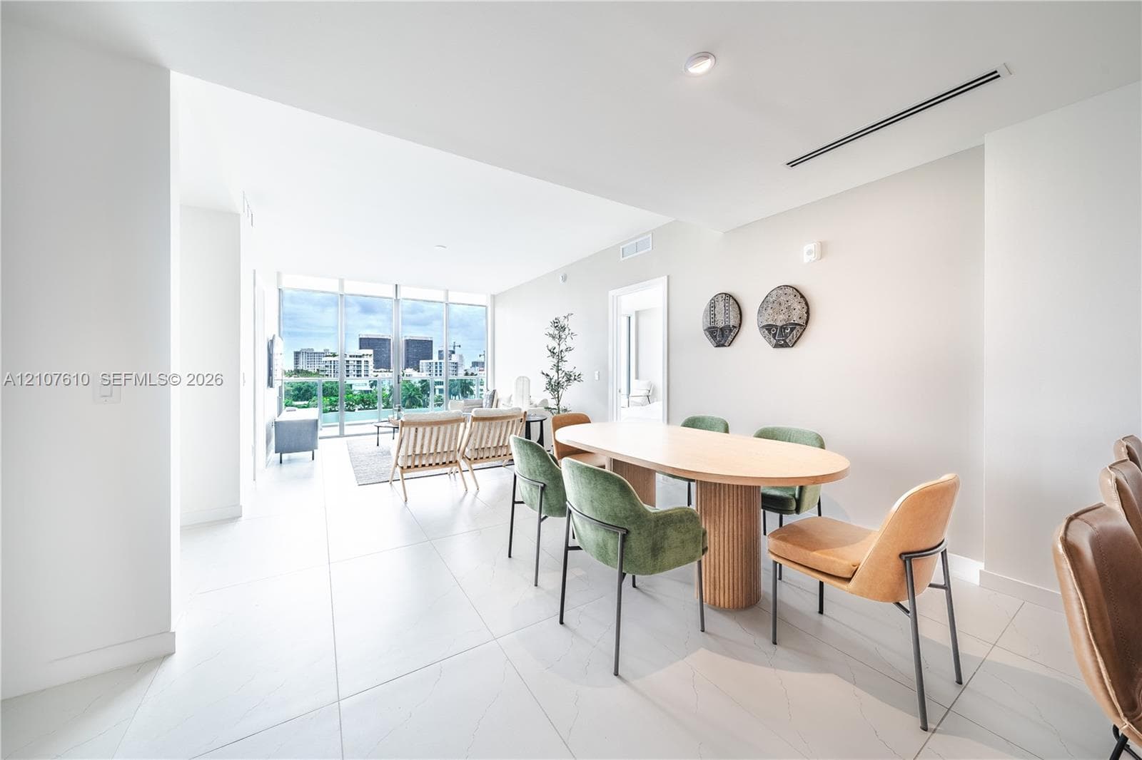 Open-concept interior featuring large-format tile flooring, floor-to-ceiling windows, and recessed ceiling lighting