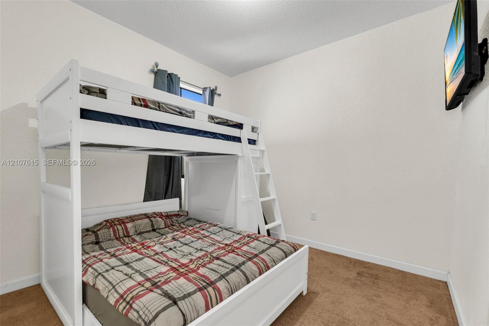 Room featuring neutral walls, textured ceiling, and wall-to-wall carpeting