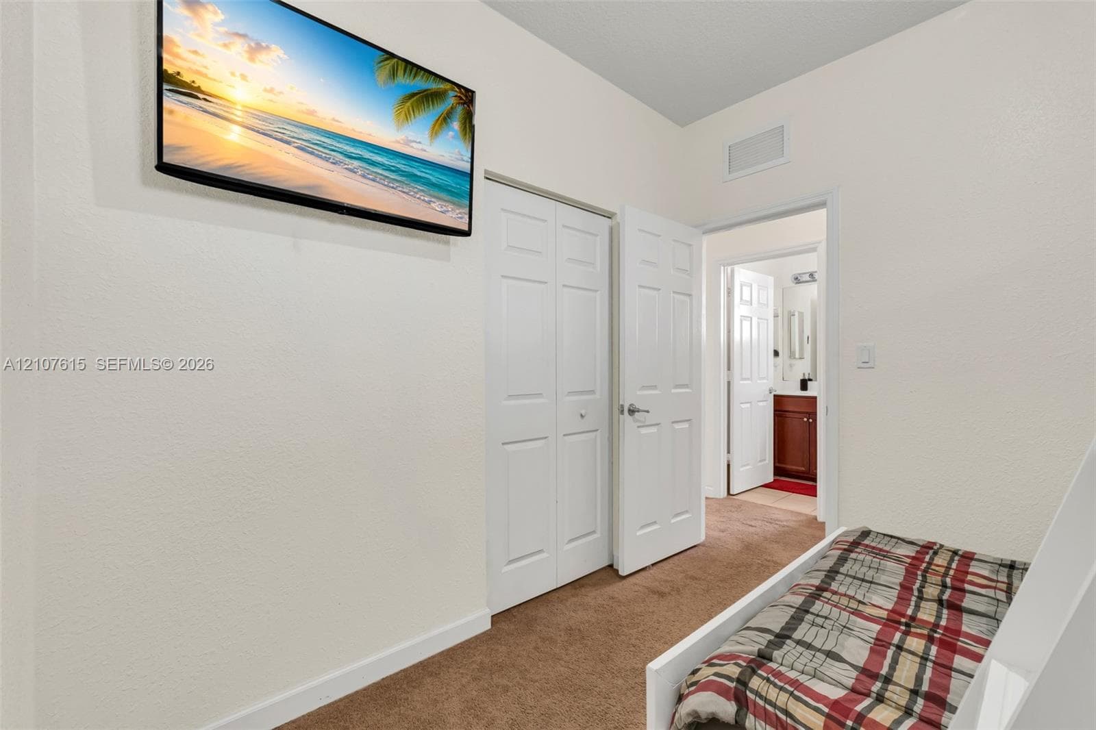 Interior space featuring carpeted flooring and a dual-panel closet door