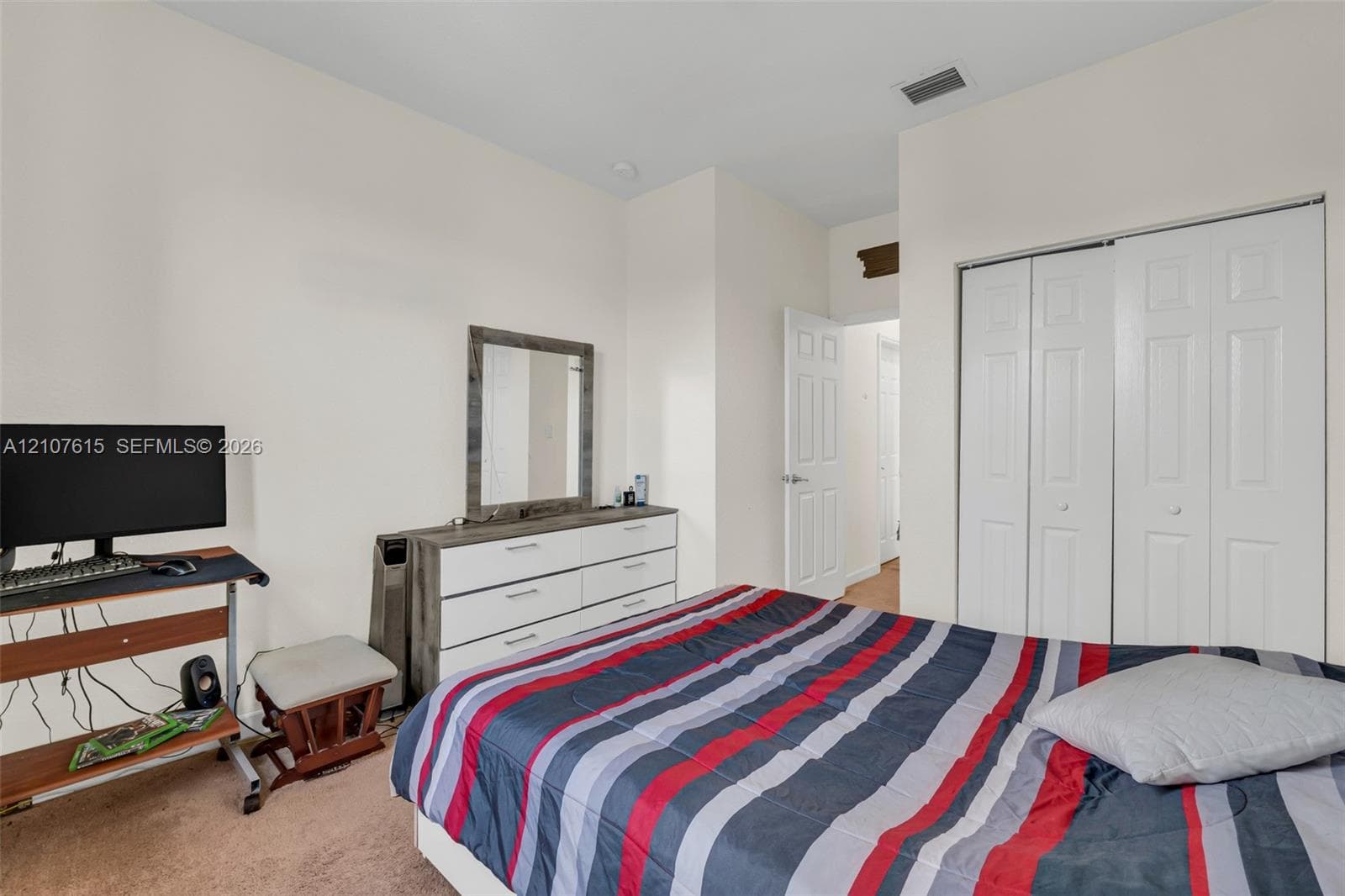 Neutral wall palette with white-paneled closet doors and interior passage door
