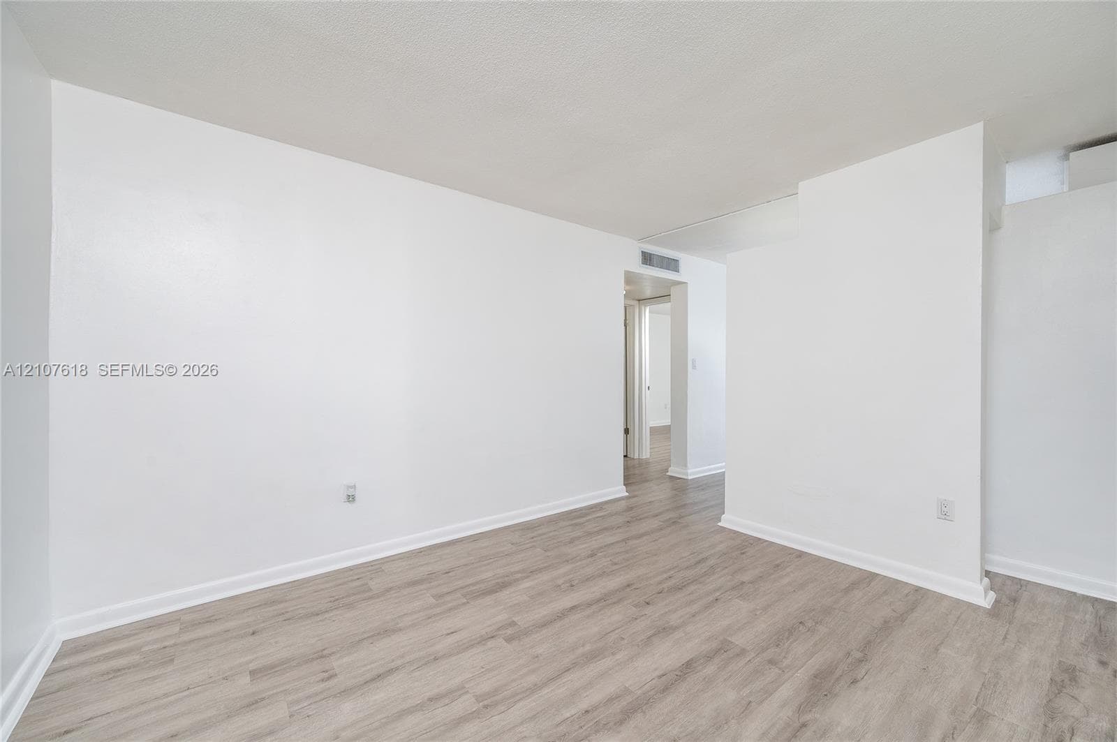 Interior space featuring neutral wall finishes and light-toned wood-finish flooring