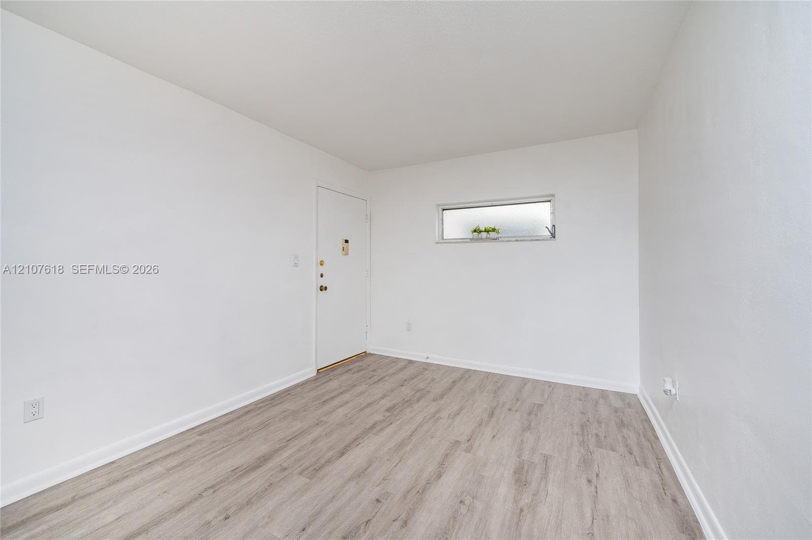 Neutral-toned wood-finish flooring and a horizontal clerestory window
