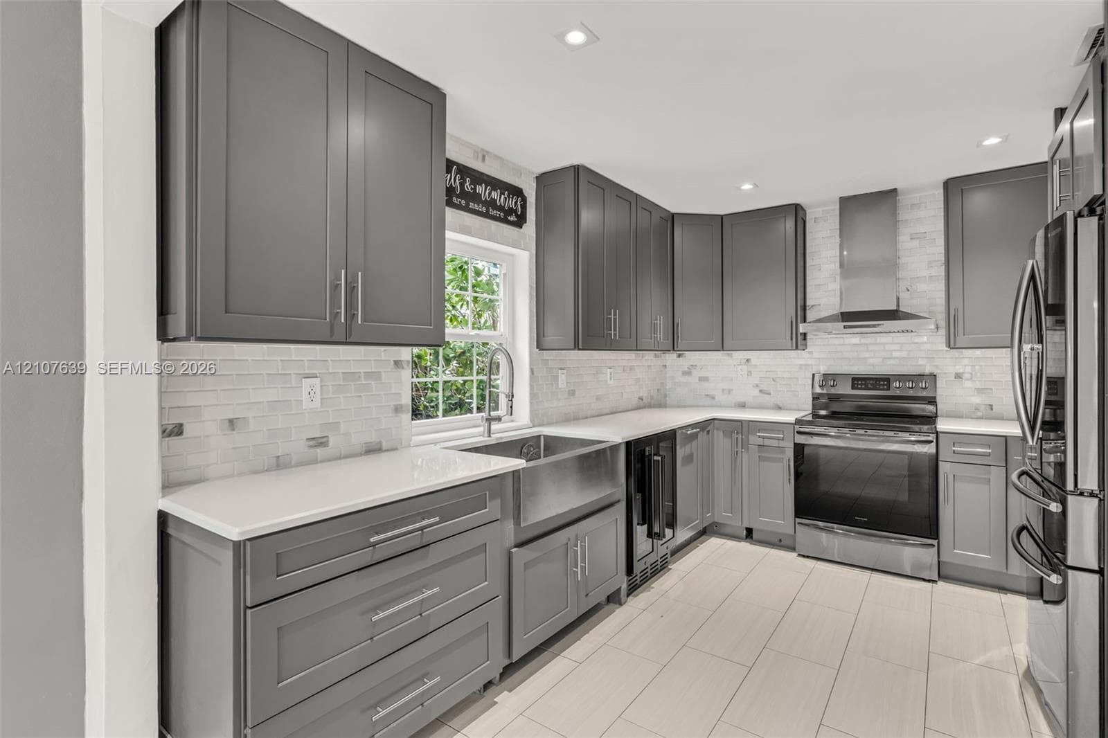 Kitchen featuring shaker-style cabinetry, white countertops, subway tile backsplash, stainless steel apron-front sink, and stainless steel appliances