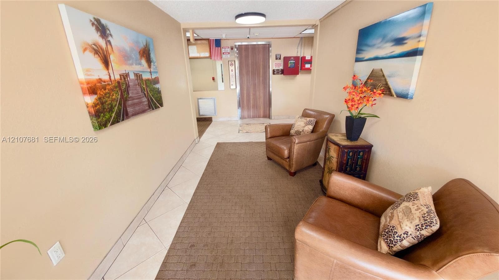 Common area lobby featuring large-format diagonal tile flooring, flush-mount ceiling lighting, and a metal-finish elevator door