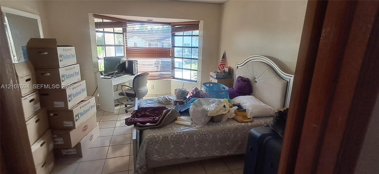 Room featuring tile flooring and a bay window configuration