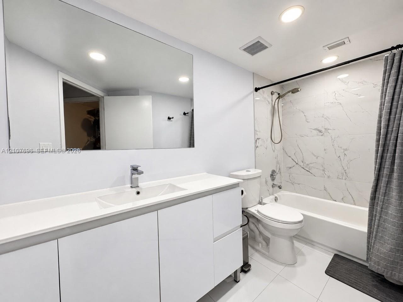 Wood-finish flooring, flush-mount ceiling lighting, and solid-core interior doors