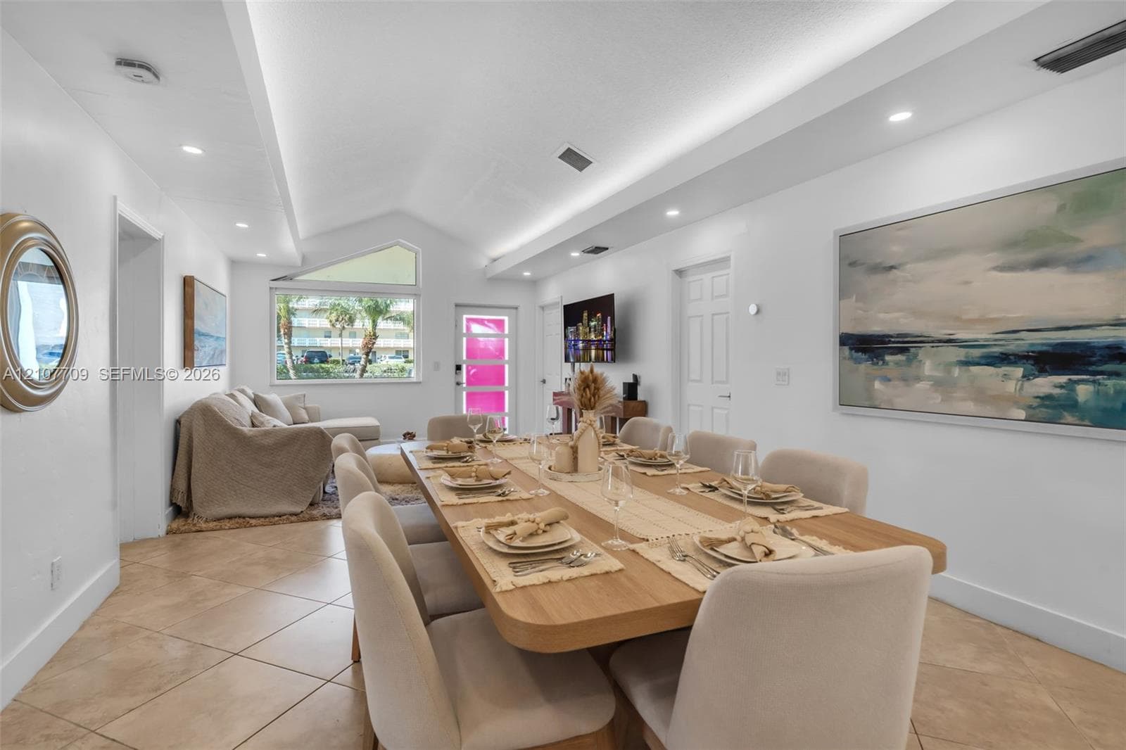 Vaulted ceilings featuring recessed lighting, tile flooring, and a triangular architectural window