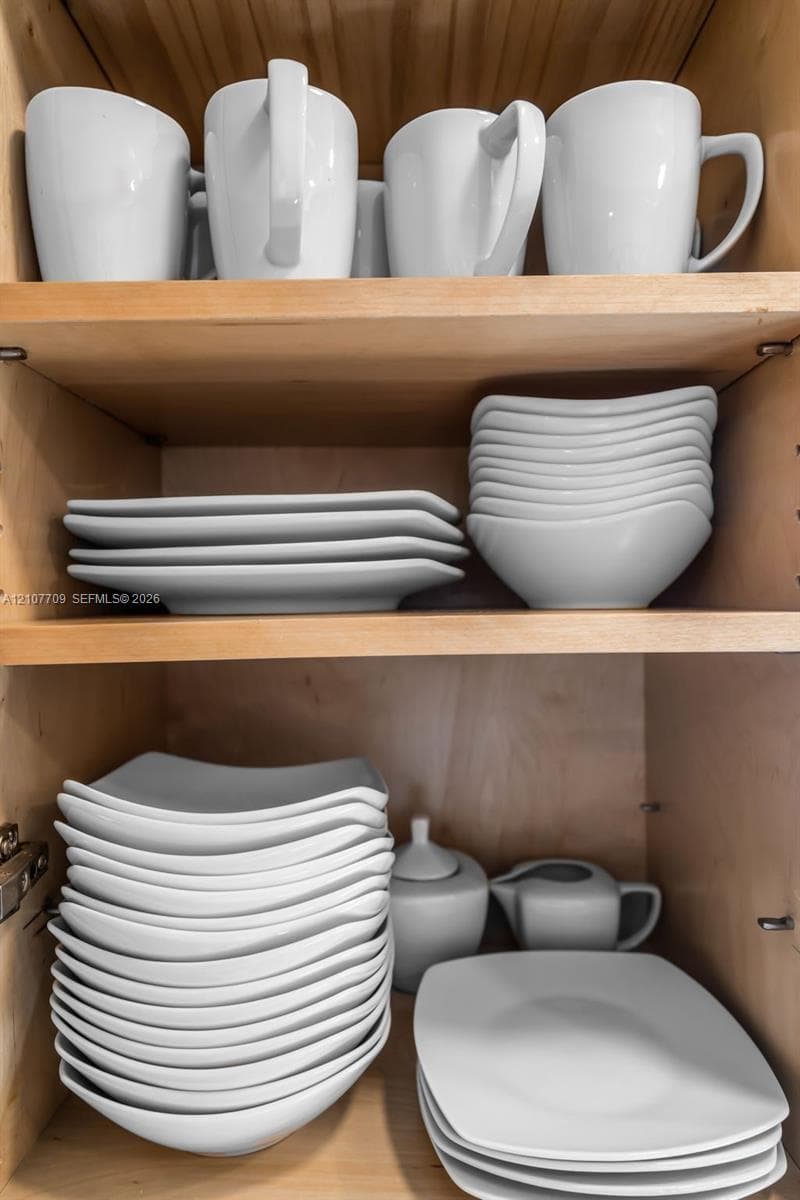 Natural wood-finish cabinetry featuring adjustable shelving and recessed metal hinge hardware
