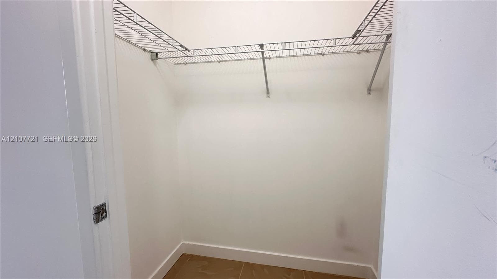 Storage closet featuring white interior walls and installed metal wire shelving