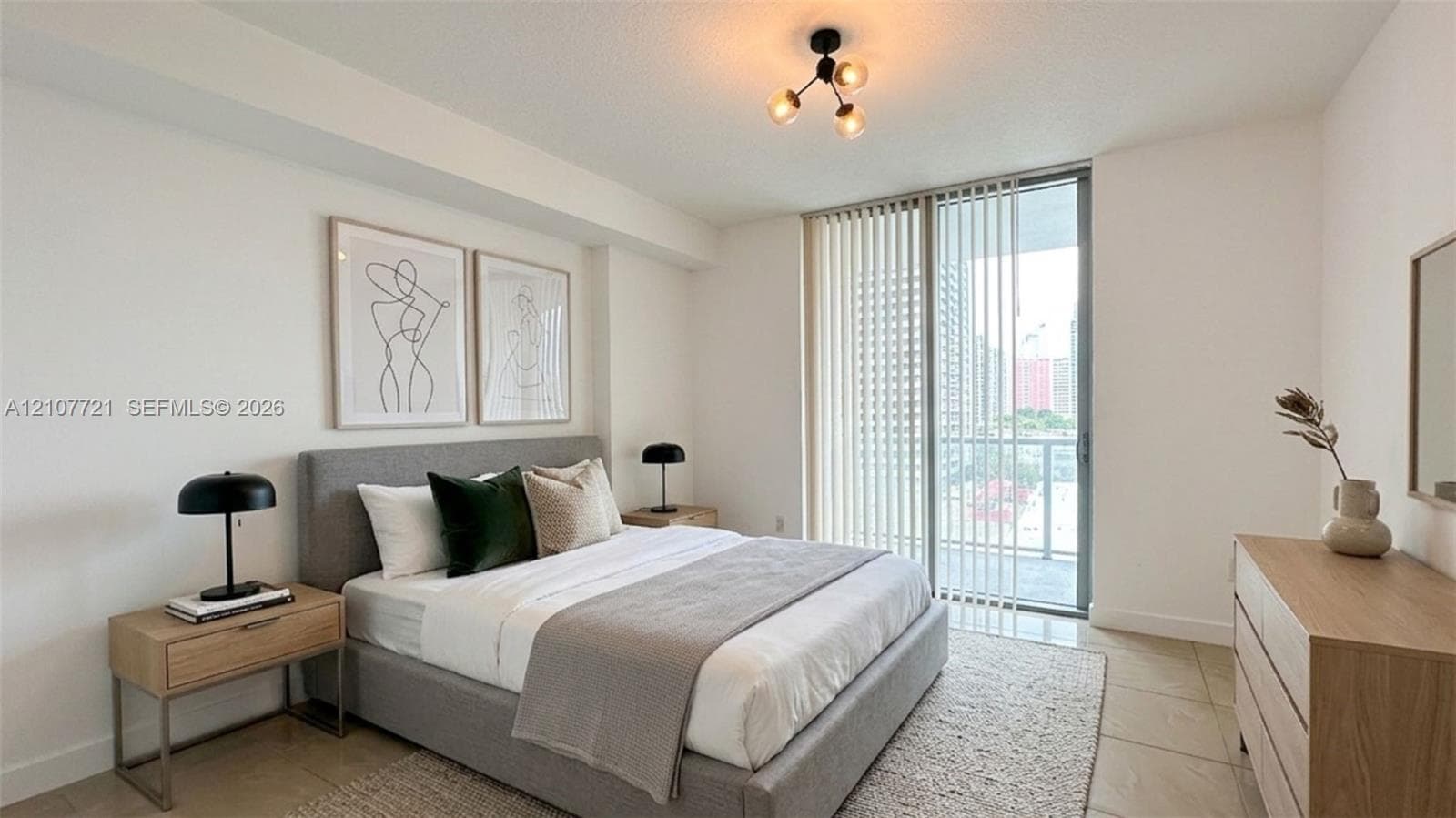 Neutral wall palette, floor-to-ceiling glass sliding doors, polished tile flooring, and contemporary multi-bulb ceiling lighting fixture