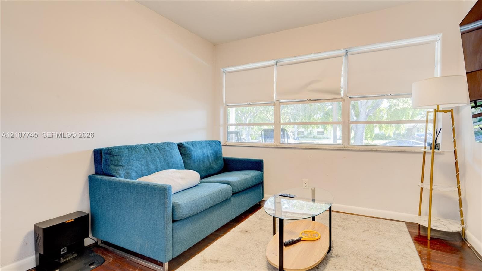 Interior space featuring wood-finish flooring and a multi-pane horizontal window configuration