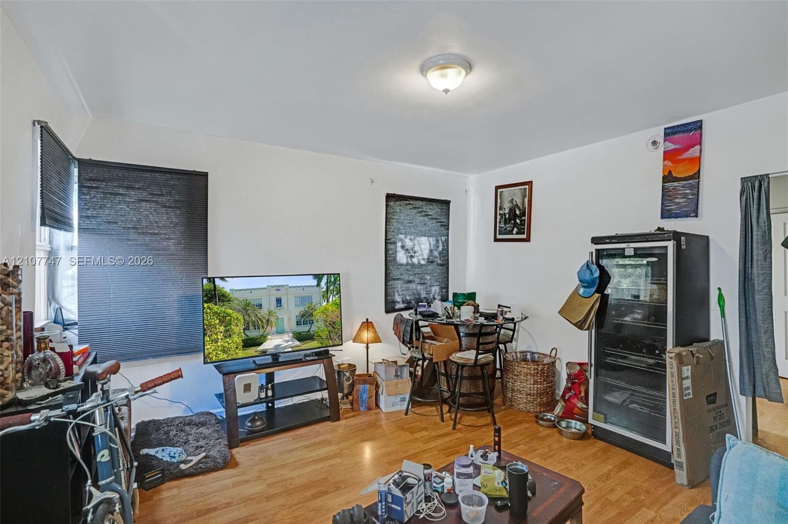 Room featuring wood-finish flooring and a central ceiling-mounted light fixture