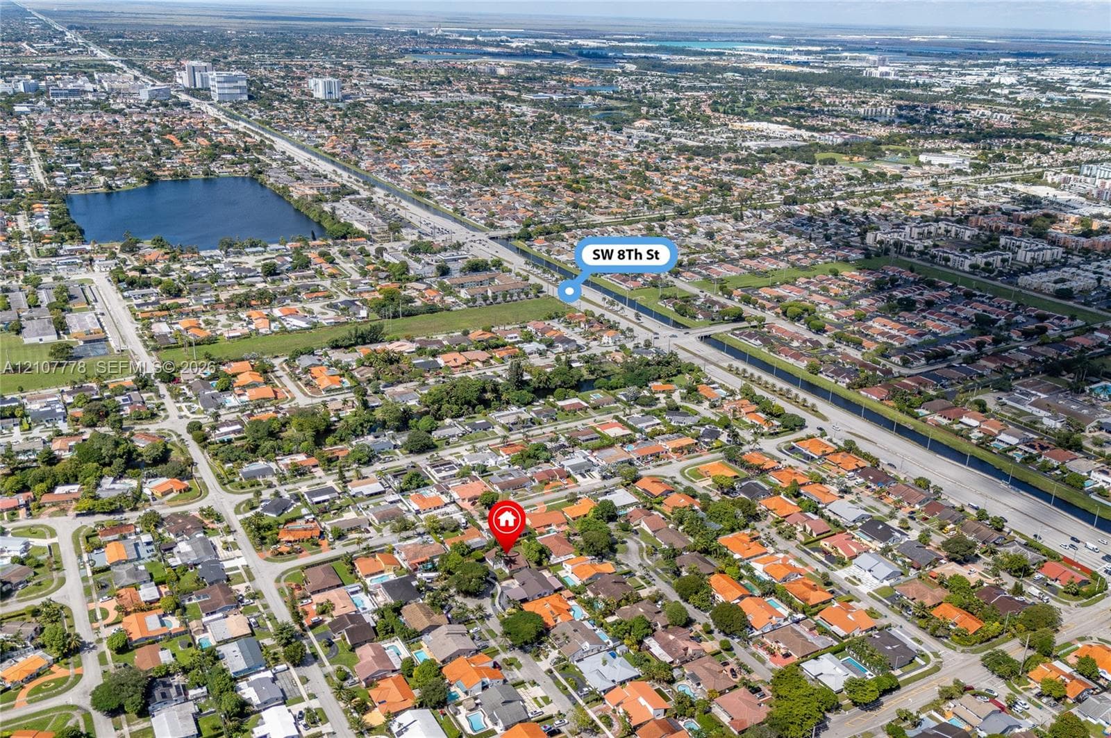 Aerial perspective of residential area featuring proximity to local thoroughfares, established neighborhood grid, mature canopy trees, and waterfront features