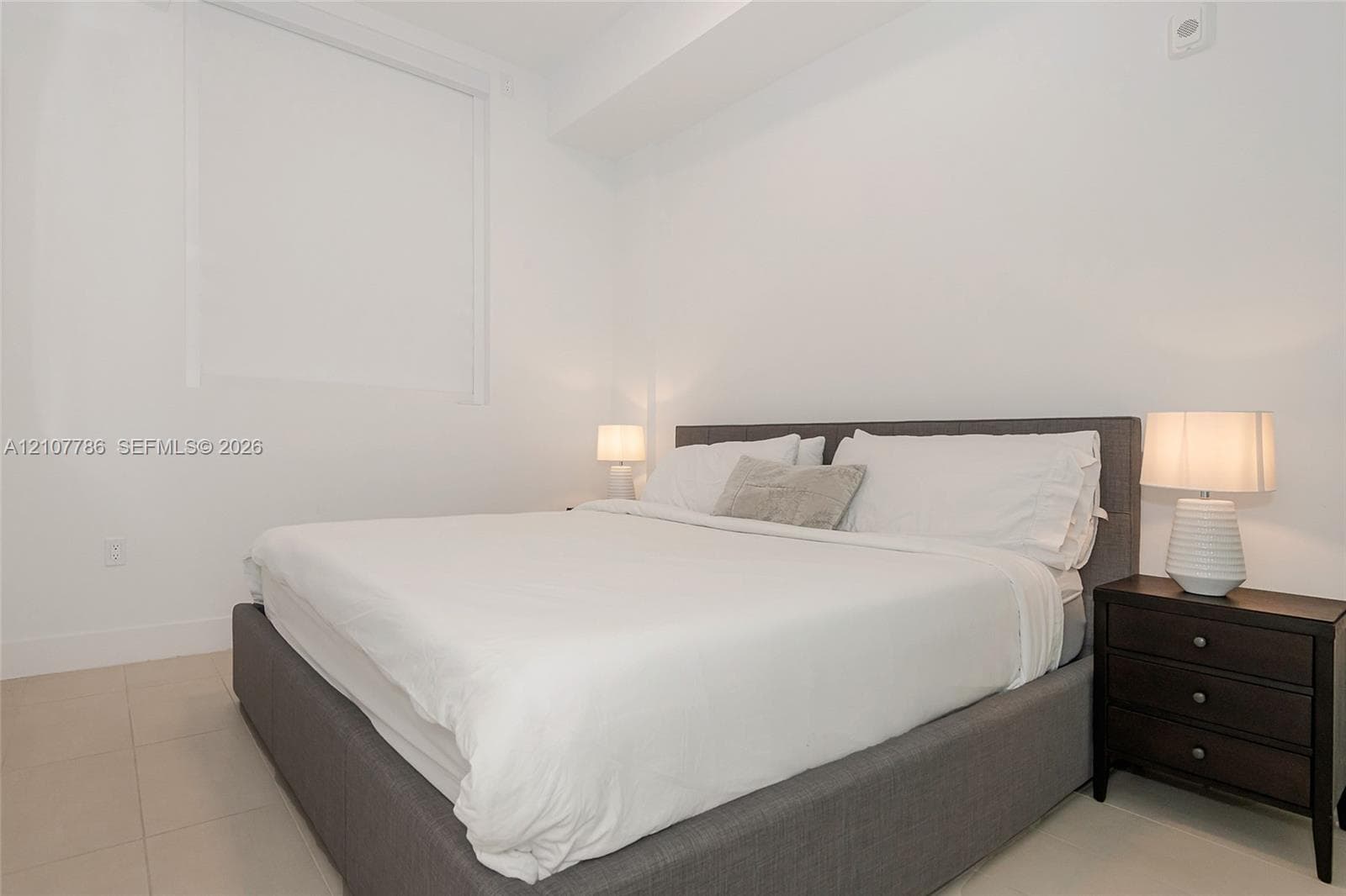 Neutral interior featuring crisp white walls and polished tile flooring