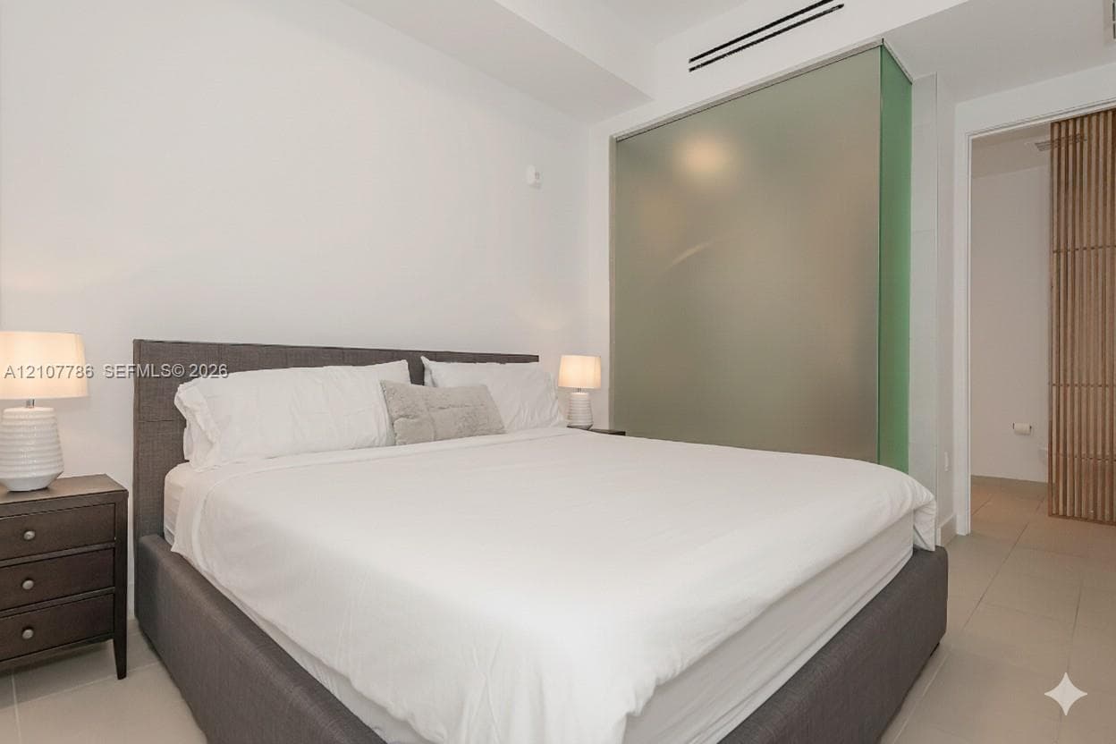 Frosted glass partition, neutral tile flooring, and vertical wood-slat screen detailing