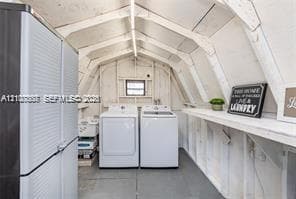 Utility space featuring a gambrel roofline, painted wood-paneled walls, built-in shelving, and a single window