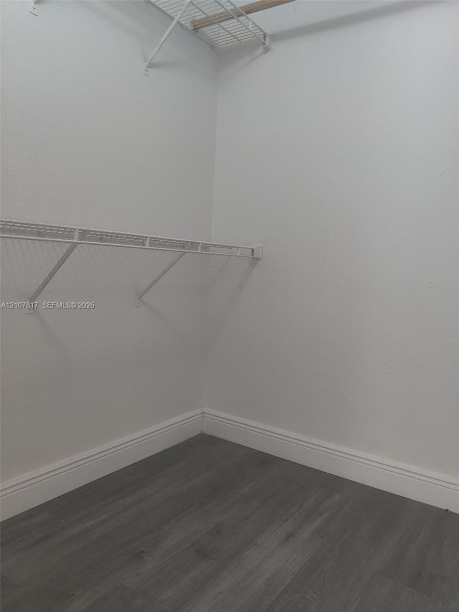 Storage area featuring wood-finish flooring and dual-level wire shelving