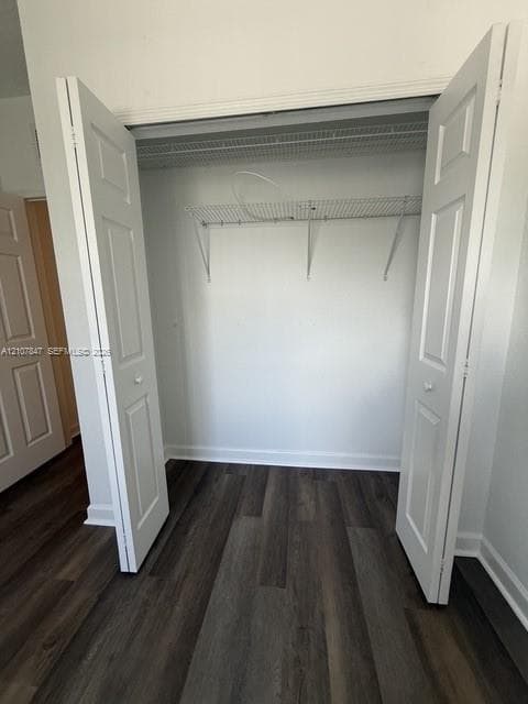 Reach-in closet featuring white bifold doors and dual-tier wire shelving