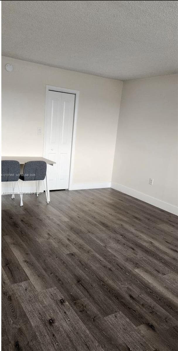 Wood-finish flooring and a white paneled door