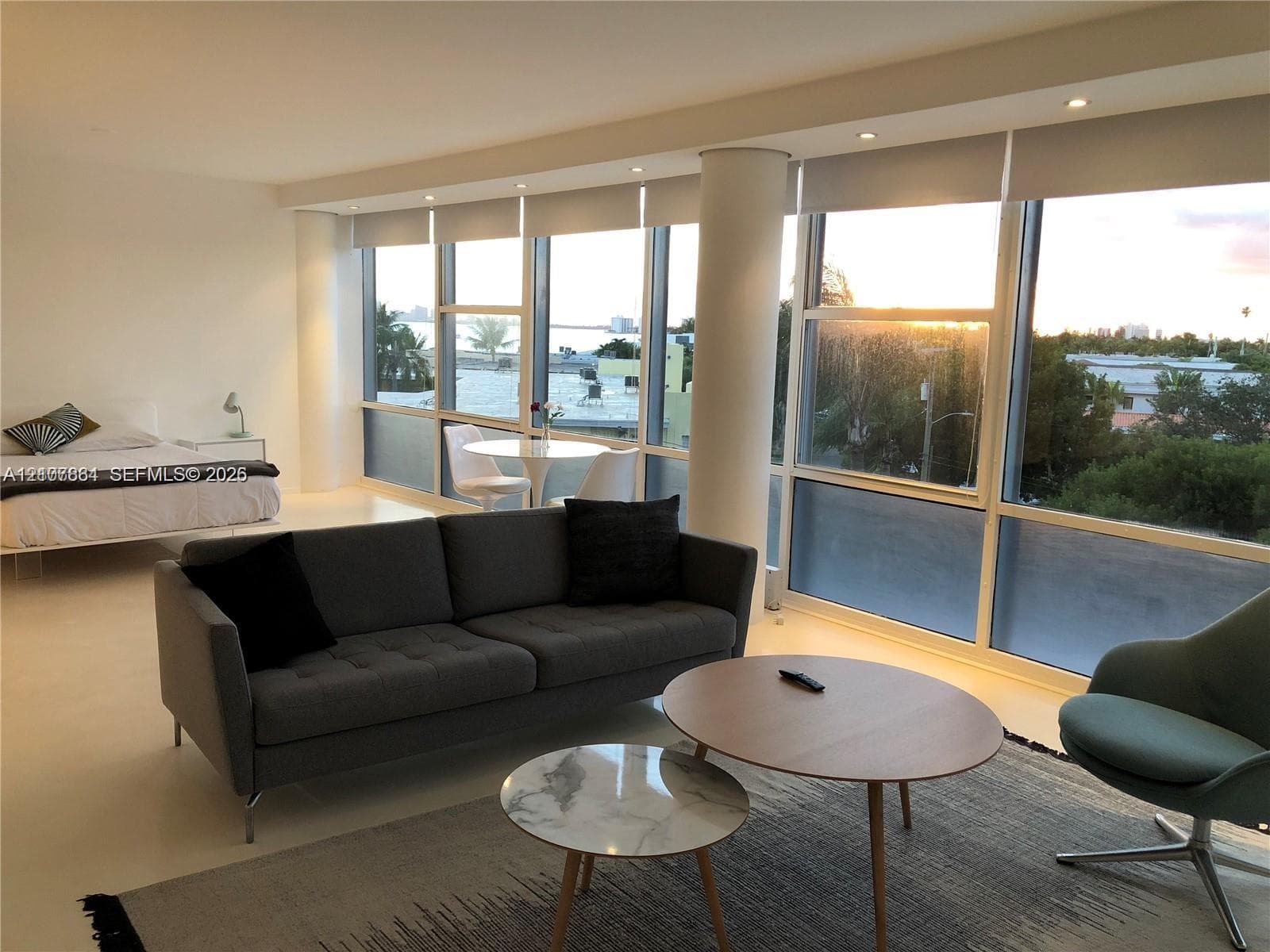 Floor-to-ceiling windows featuring expansive exterior exposure, recessed lighting, smooth-finish concrete flooring, and structural columns
