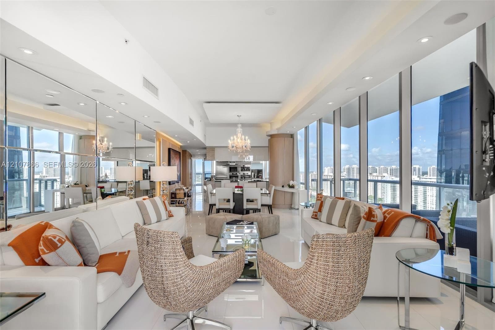 Floor-to-ceiling windows, full-wall mirror installation, polished tile flooring, recessed ceiling lighting, and built-in crystal chandelier