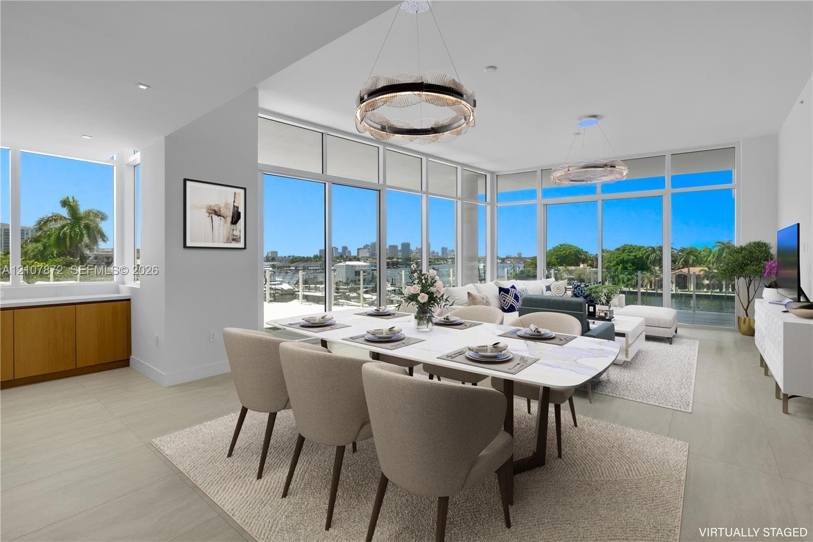 Open-concept living space featuring floor-to-ceiling windows, porcelain tile flooring, built-in lower cabinetry with wood finish, and recessed lighting