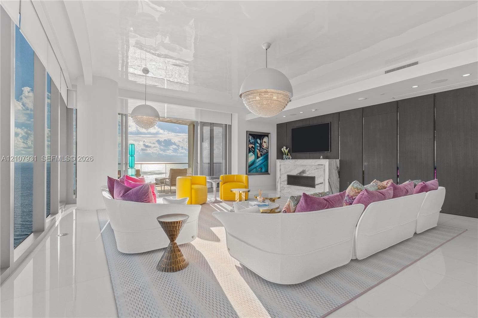 Floor-to-ceiling glass walls, stone-surround fireplace, high-gloss ceiling finish, and dual oversized spherical pendant lighting