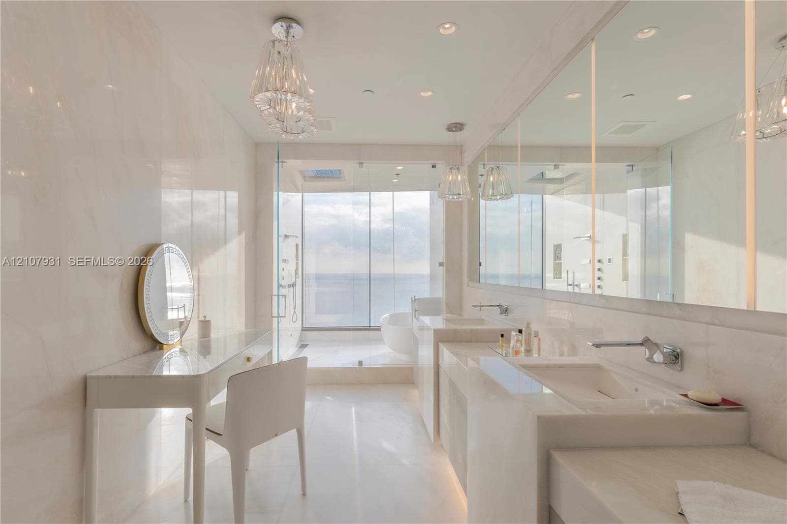 Bathroom featuring floor-to-ceiling stone wall cladding, dual integrated stone sinks, wall-mounted chrome faucets, glass-enclosed shower, and built-in stone vanity