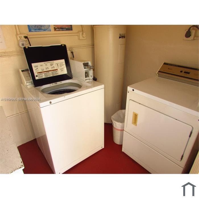 Dedicated laundry area featuring a top-load washer, front-load dryer, and water heater