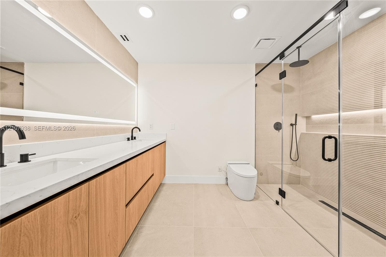 Double vanity featuring a light wood-finish cabinet, white solid-surface countertop, and matte black fixtures