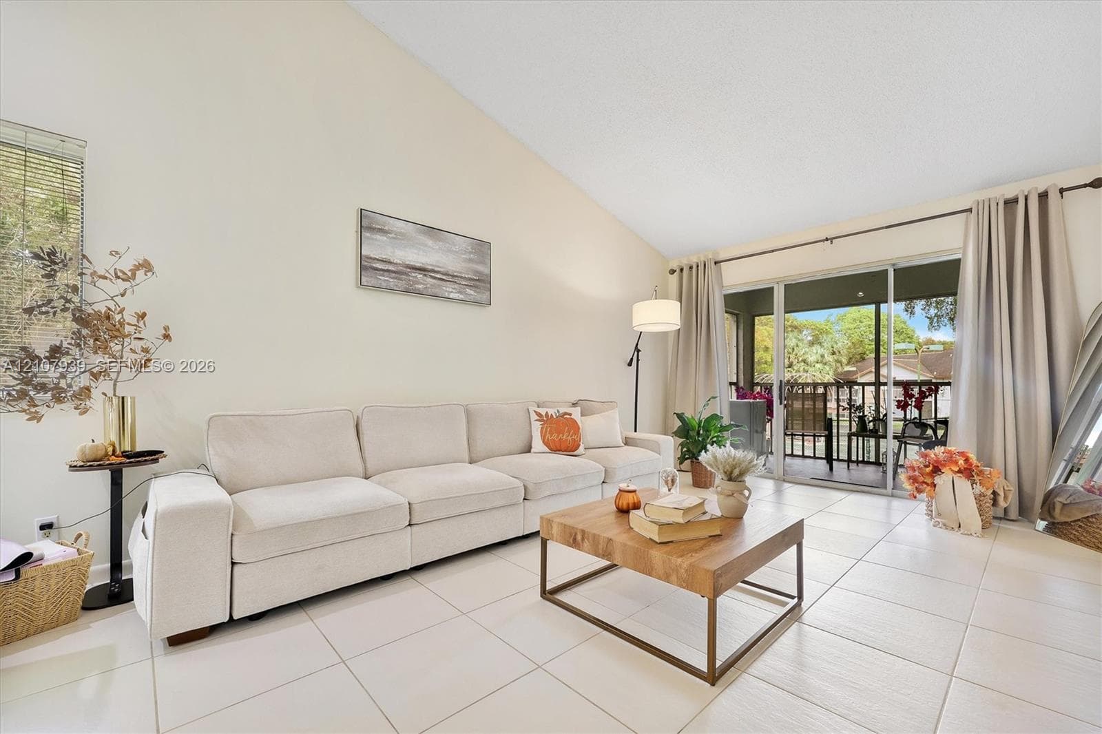 Vaulted ceilings, large-format tile flooring, and glass sliding doors providing external access