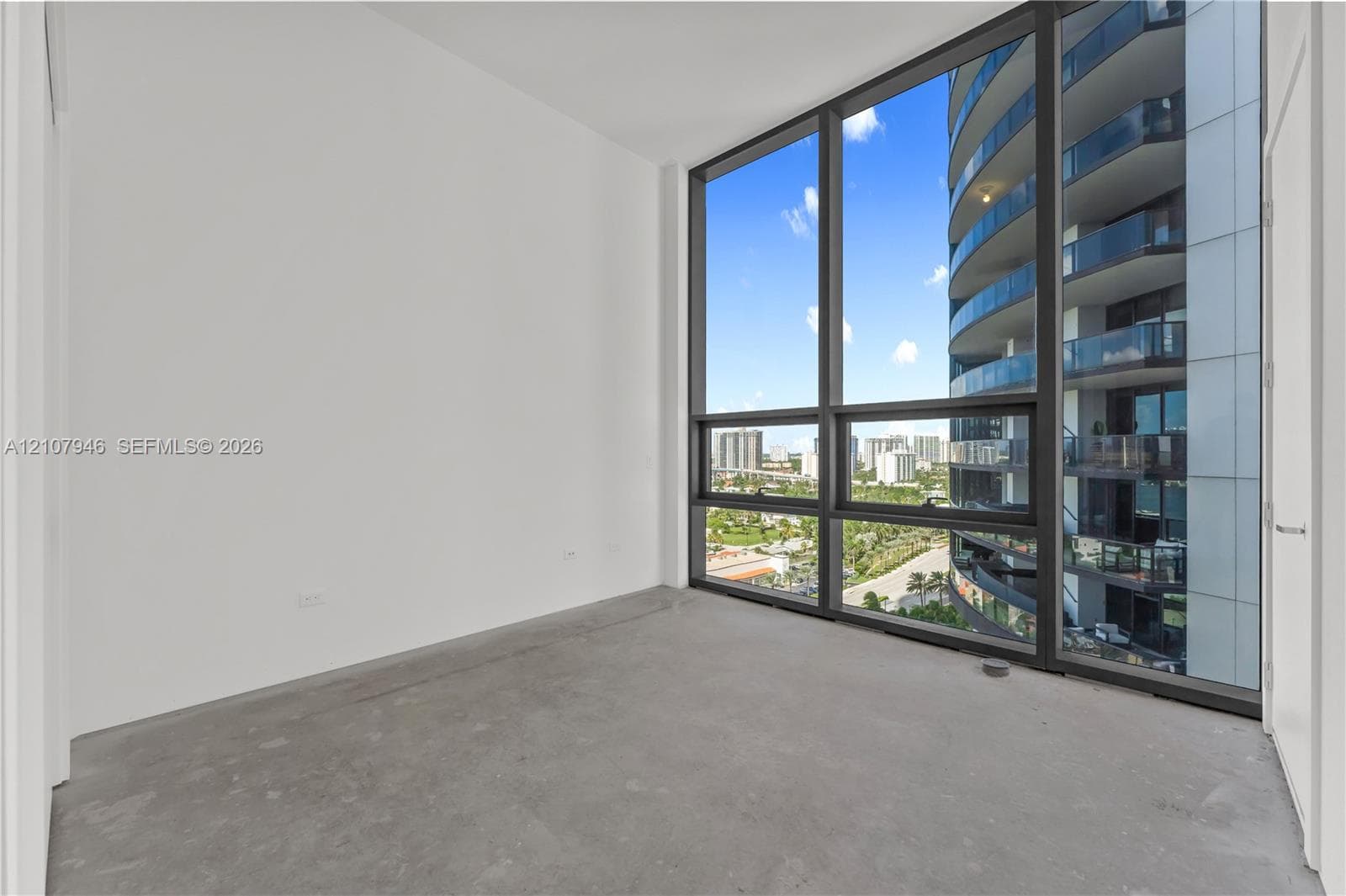 Floor-to-ceiling windows featuring dark metal frames and neutral interior wall finishes