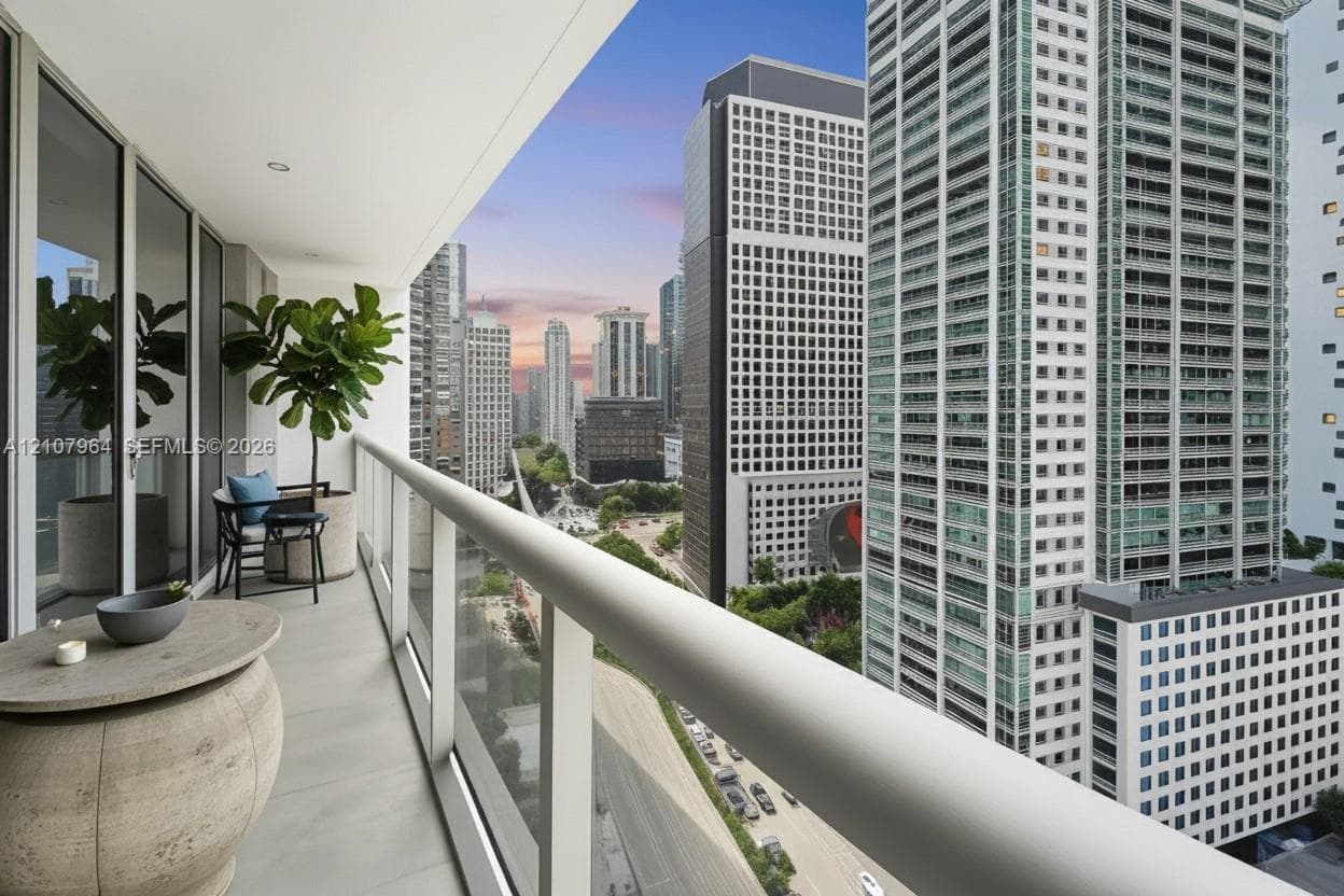 Covered outdoor balcony featuring a glass-panel railing, Virtually Staged