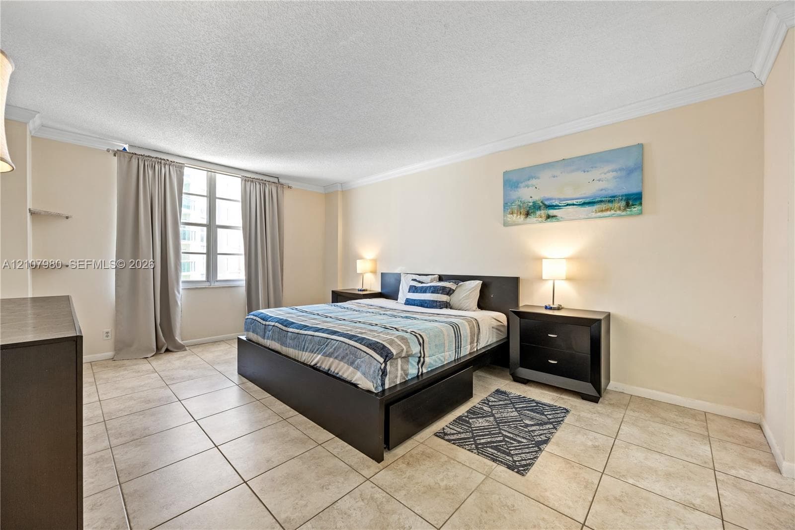 Neutral-toned ceramic tile flooring, multi-panel window, crown molding, and built-in wall shelving