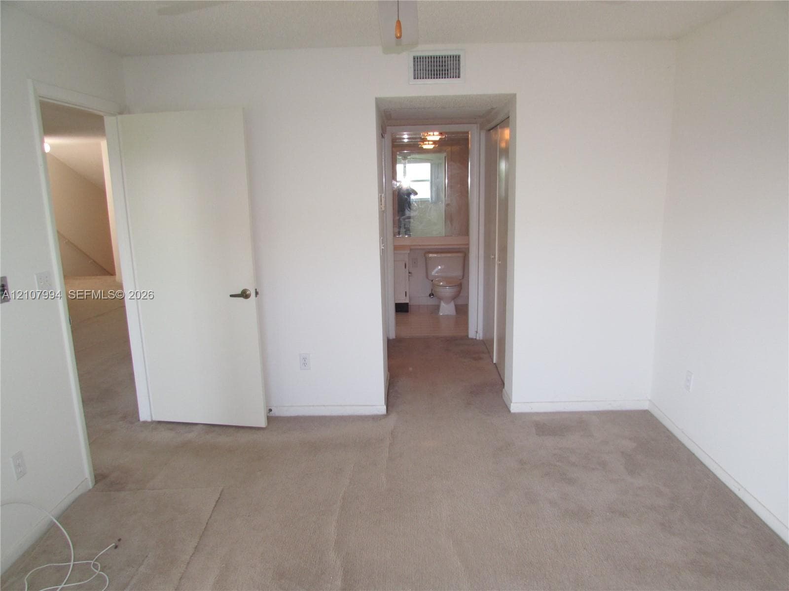 Neutral-toned carpeting, solid-core interior doors, and built-in closet storage