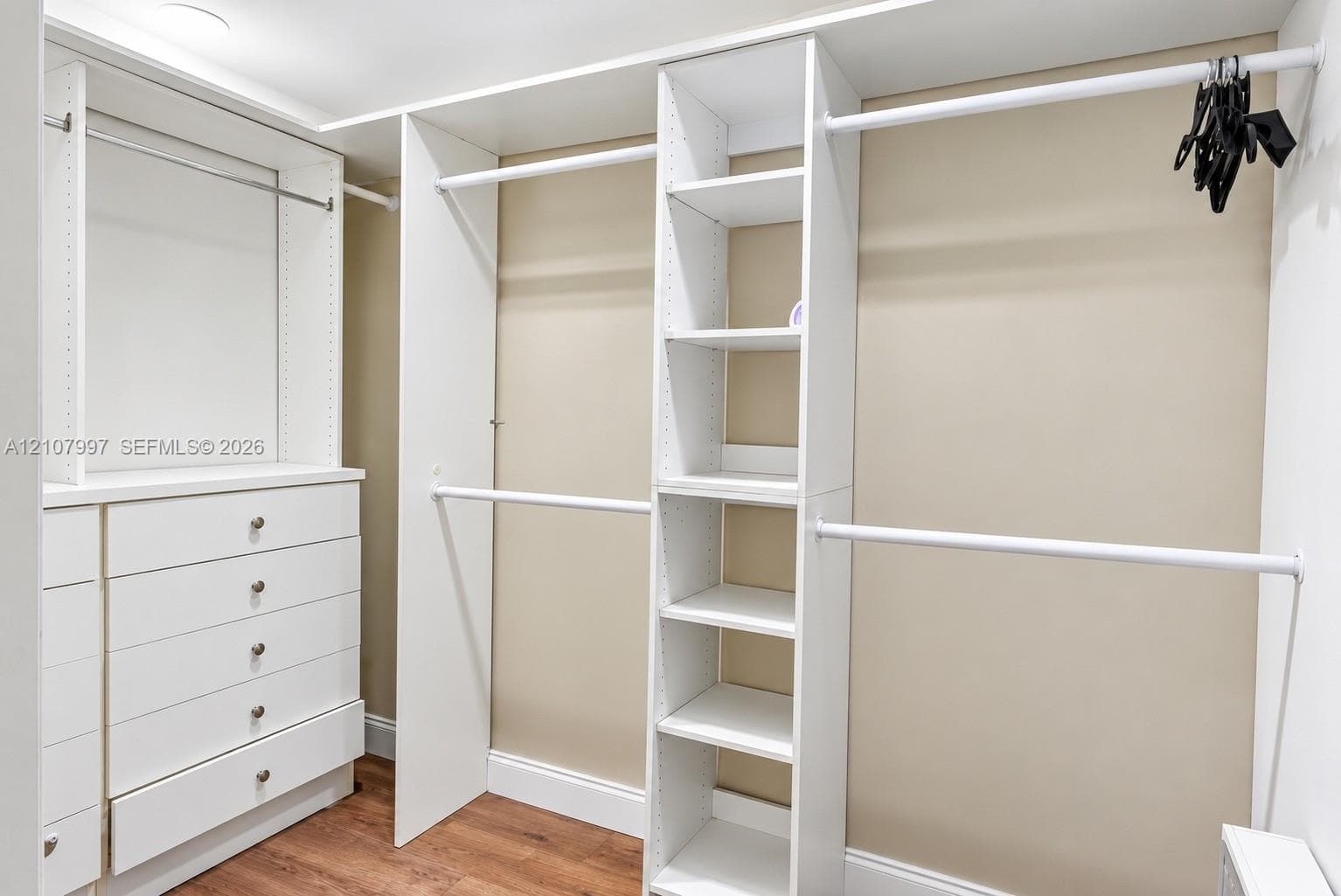 Second bedroom featuring wood-finish flooring.