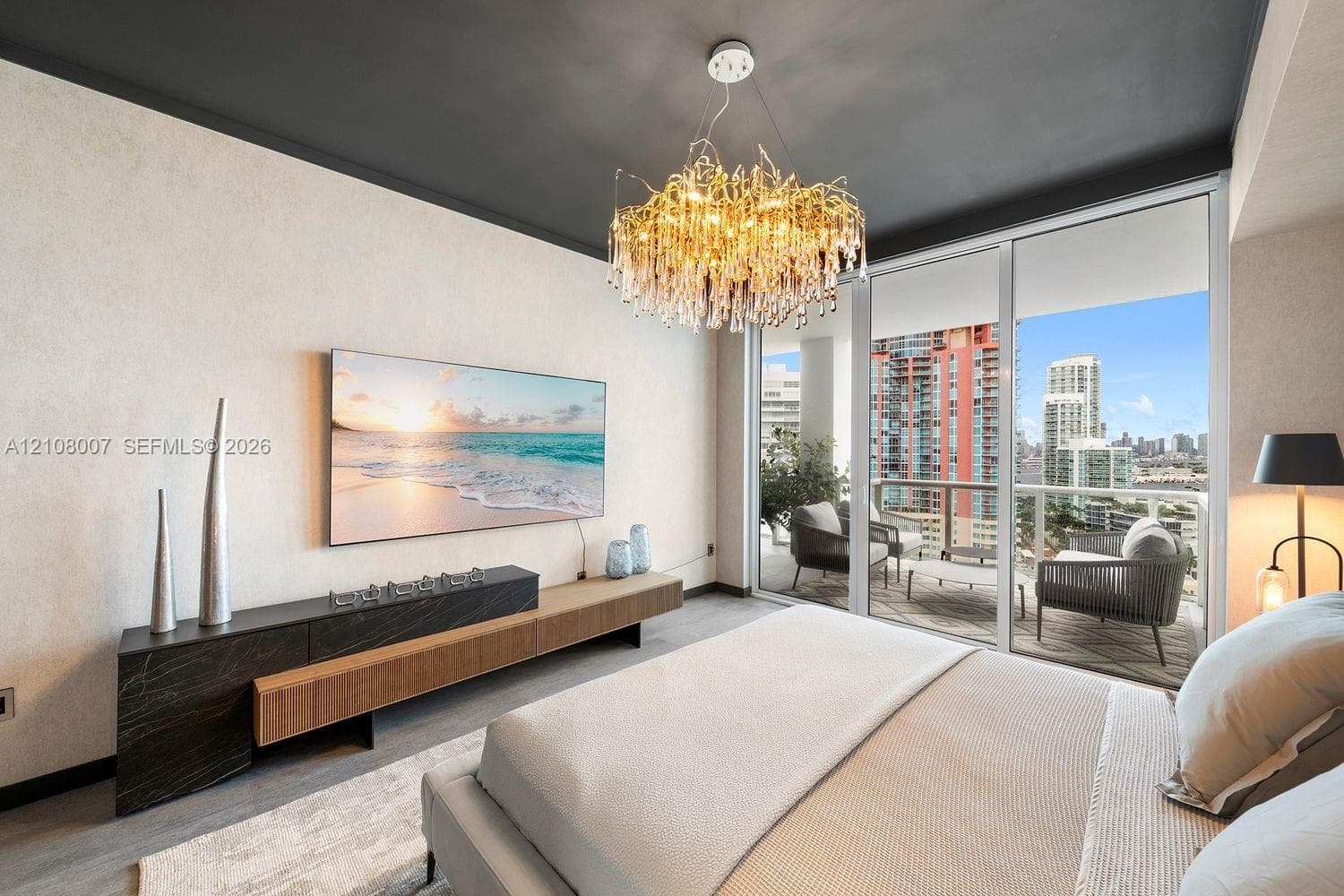 Floor-to-ceiling glass sliding doors, custom wall-mounted storage cabinetry with dark stone surfacing and wood-finish accents, decorative crystal-style chandelier, and painted ceiling