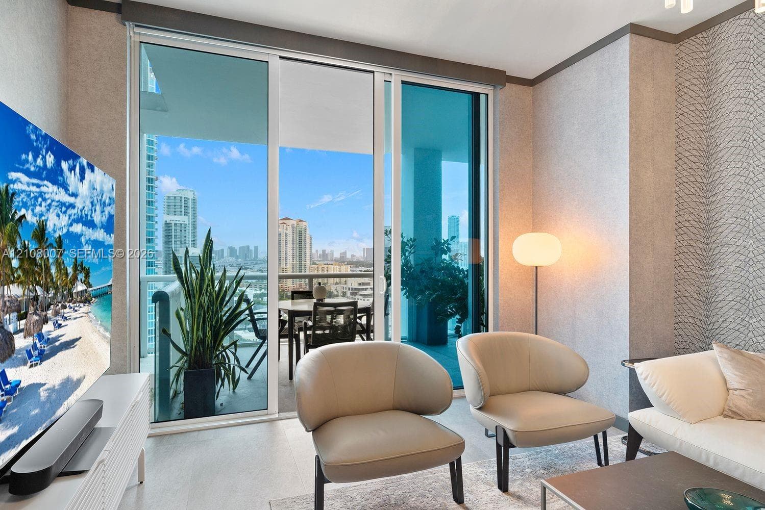 Floor-to-ceiling sliding glass doors, private balcony, neutral-toned textured wall covering, and light-toned flooring