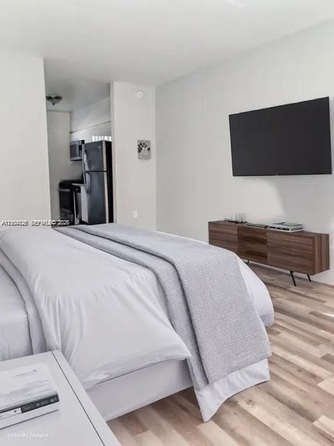 Neutral-toned interior featuring wood-finish flooring and a wall-mounted display area