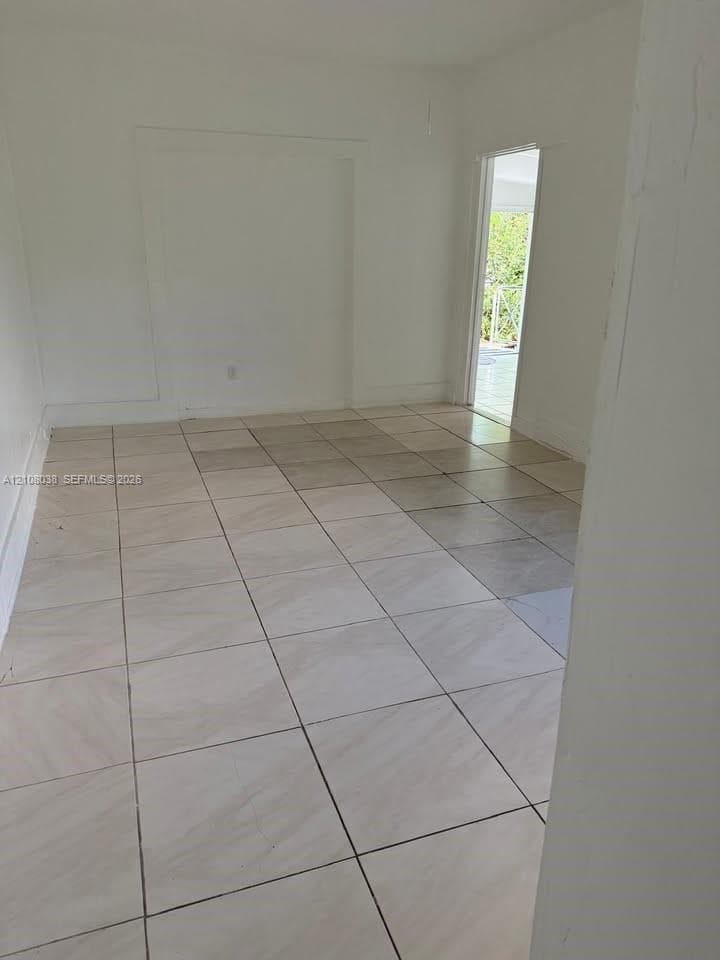 Interior room featuring large-format ceramic tile flooring and a recessed wall niche