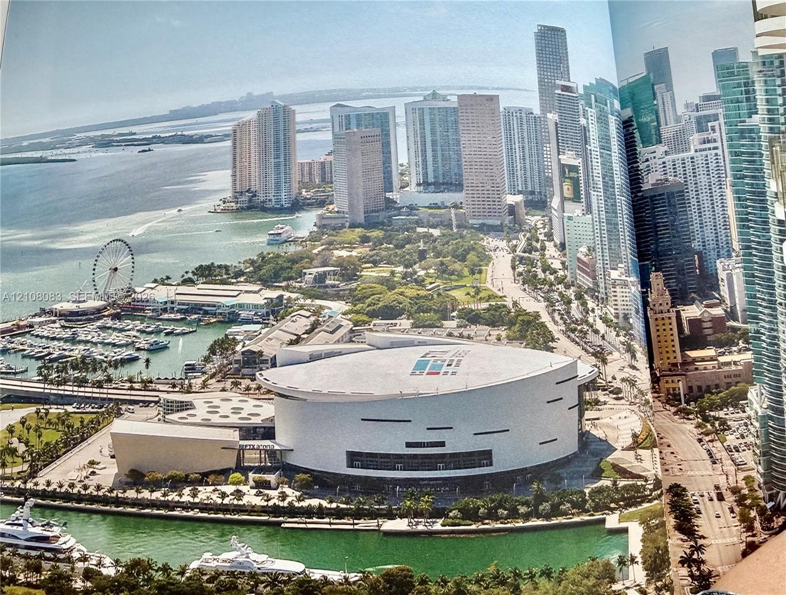 Aerial perspective featuring urban skyline, waterfront access, cityscape architecture, marina, and proximity to major commercial district