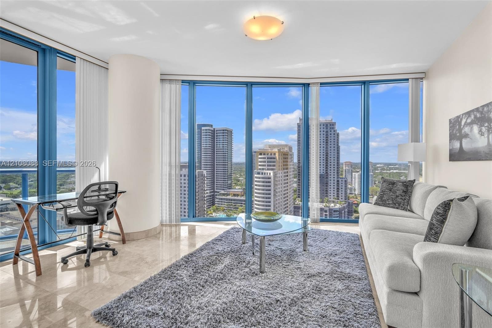 Floor-to-ceiling windows, polished stone flooring, and structural column