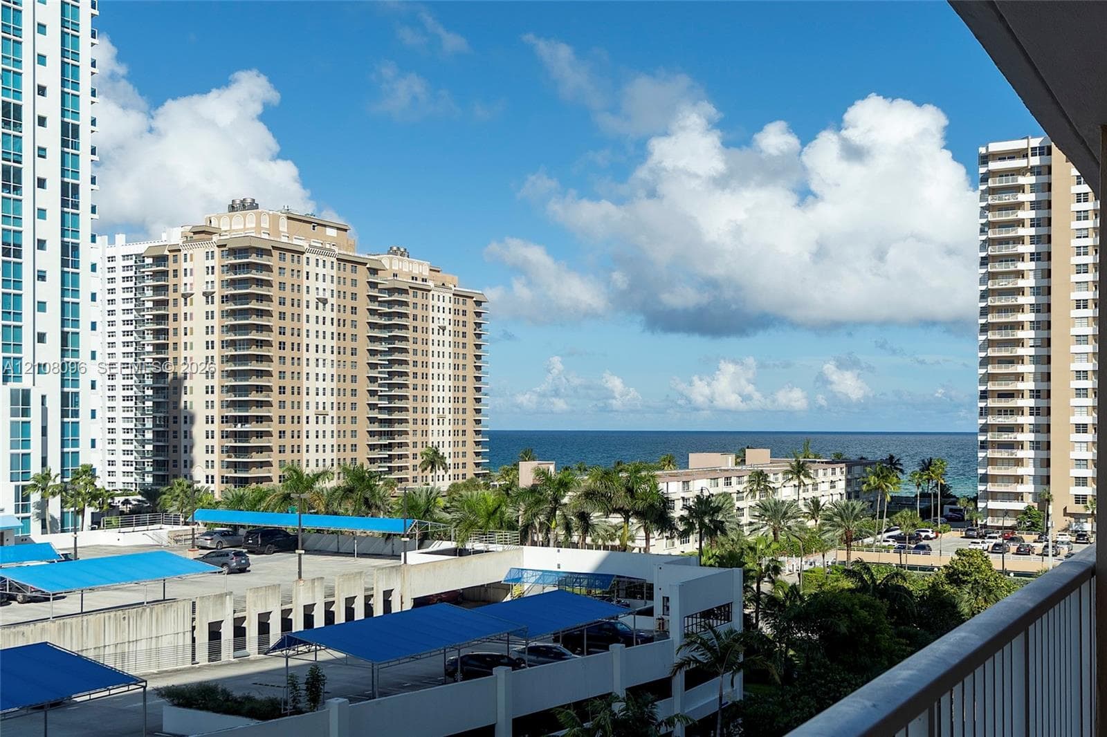 Balcony overlooking the coastline with palm trees and ocean horizon