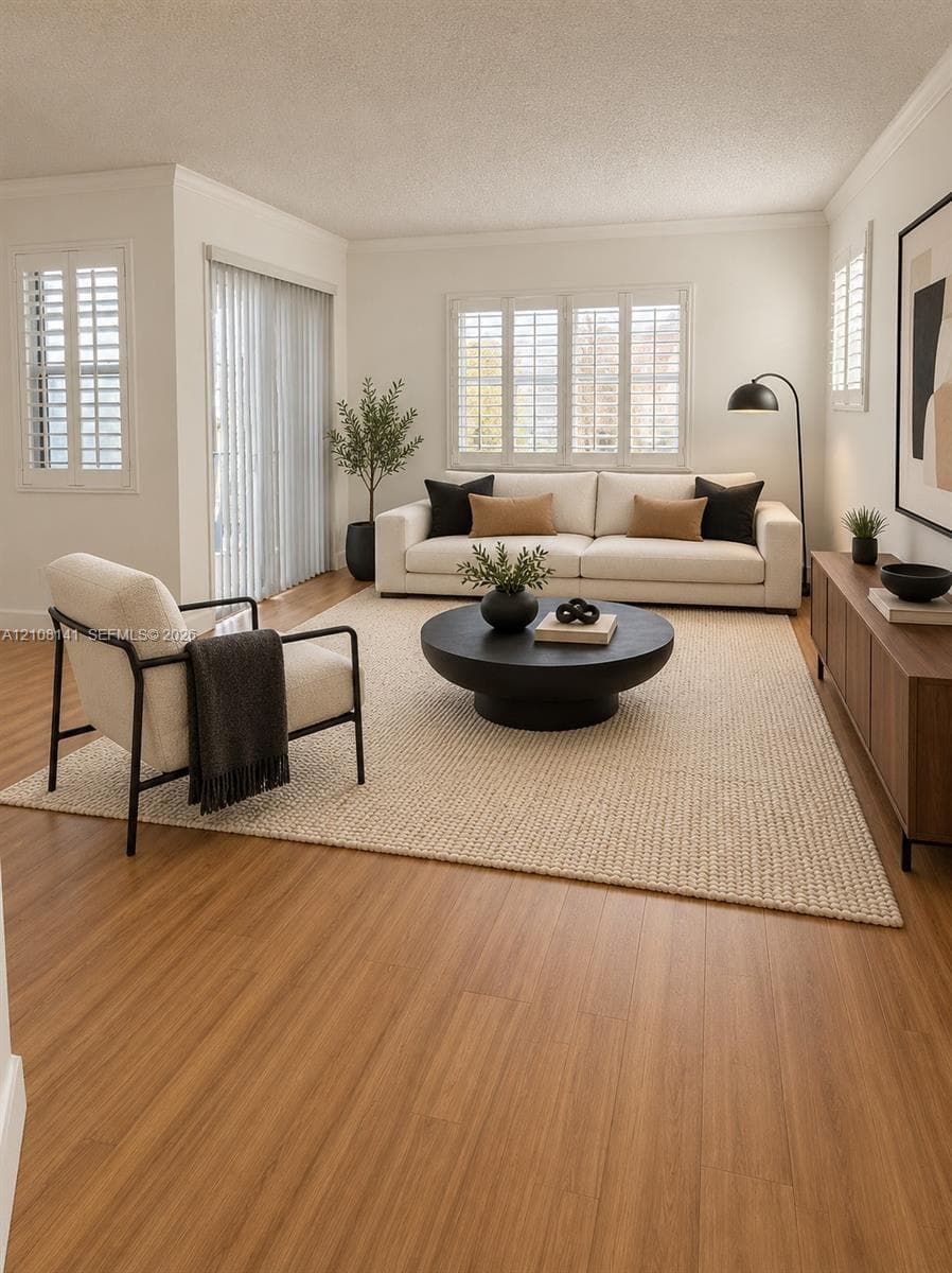 Living area featuring wood-finish flooring, plantation shutters, and sliding glass door access