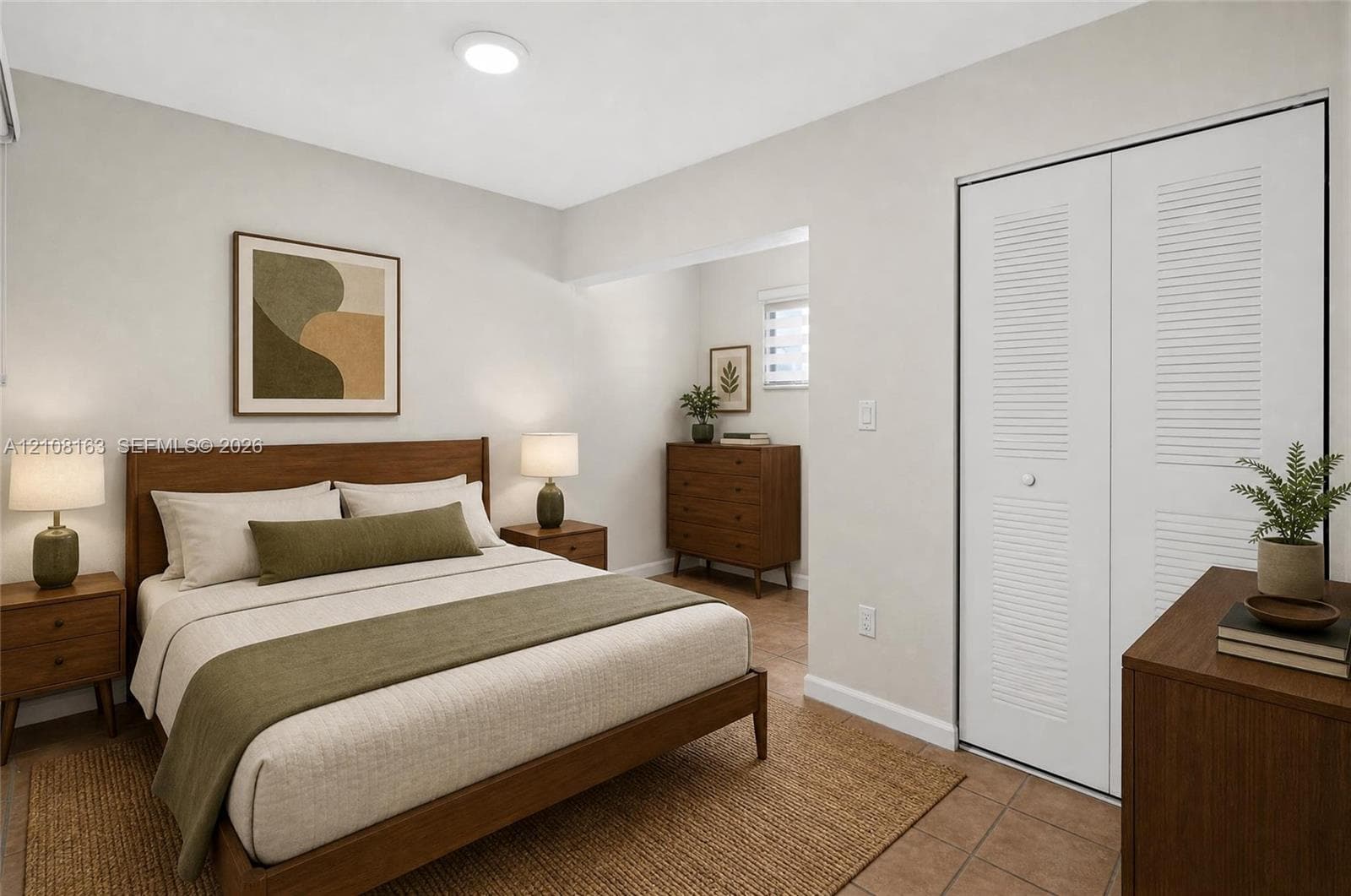 Neutral-toned walls, tile flooring, and closet featuring white dual-panel louvered doors
