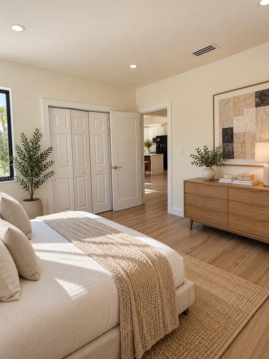 Wood-finish flooring, recessed lighting, and white six-panel closet doors