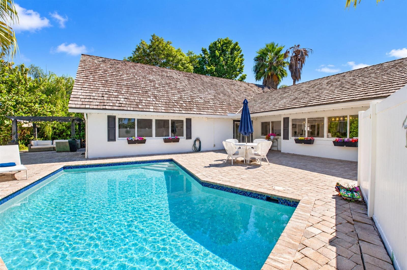View of back of home and pool